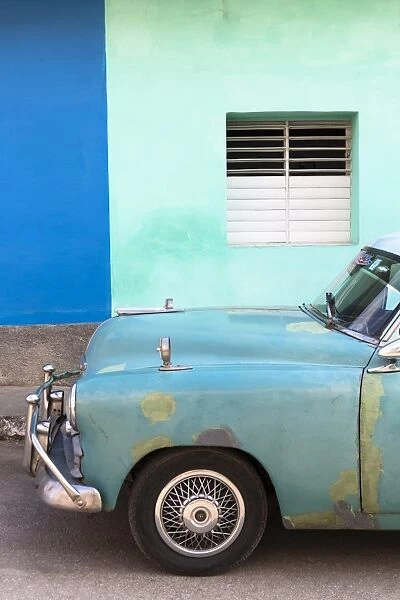 Vintage American car parked in front of the green and blue walls of a colonial building, Trinidad, Sancti Spiritus, Cuba, West Indies, Caribbean, Central America