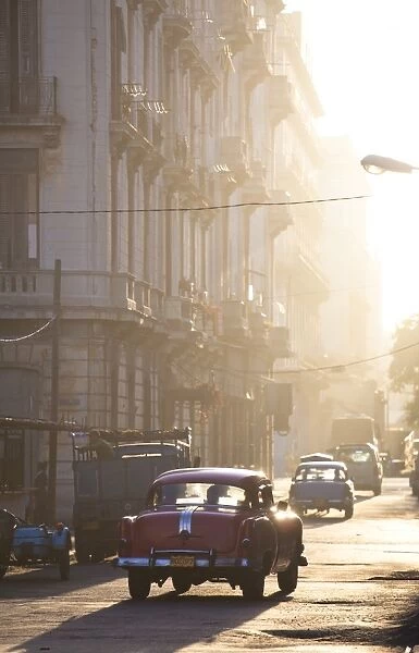 Vintage American car taxi on Avenue Colon during morning rush hour soon after sunrise, Havana Centro, Cuba, West Indies, Central America