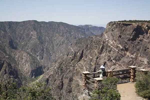 Visitor at Painted Wall View Point, Gunnison River deep in the canyon, Black Canyon of the Gunnison National Park, Colorado, United States of America, North America