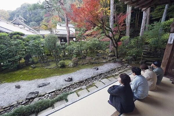 Visitors contemplating the garden at Nison in (Nisonin) Temple dating from 834