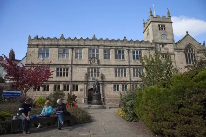 Framed Print : Visitors sitting in front of Statue of Charles Darwin outside Public Library