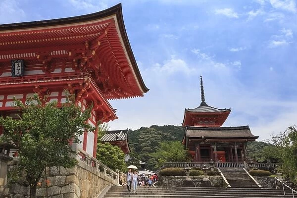 Visitors with sun umbrella in summer, vermillion temple entrance buildings, Kiyomizu-dera