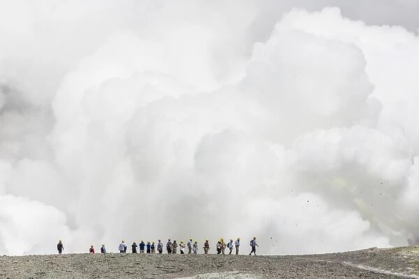 Visitors watching mud being ejected from the caldera floor of an active andesite stratovolcano on White Island, North Island, New Zealand, Pacific