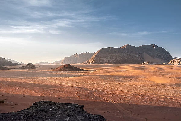 Wadi Rum plain at sunrise with soft light over the sand dunes and mountains, UNESCO World Heritage Site, Jordan, Middle East