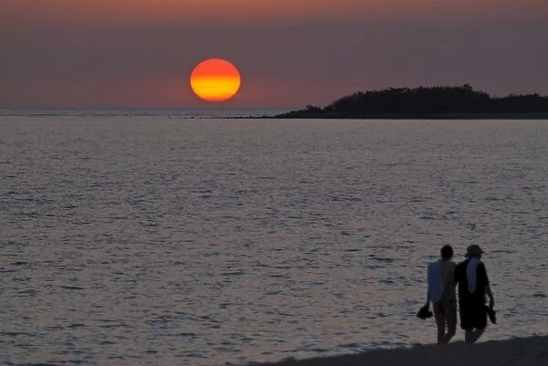 Walking couple at sunset, Playa Ancon, Trinidad, Cuba, West Indies, Caribbean