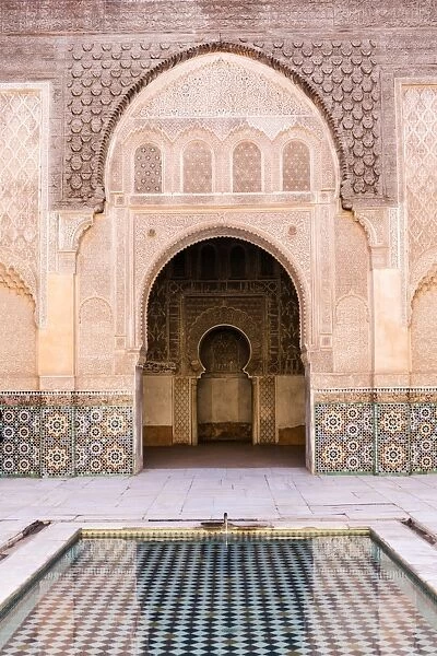 Wall of Ben Youssef Madrasa (ancient Islamic college) with reflection in pool of water