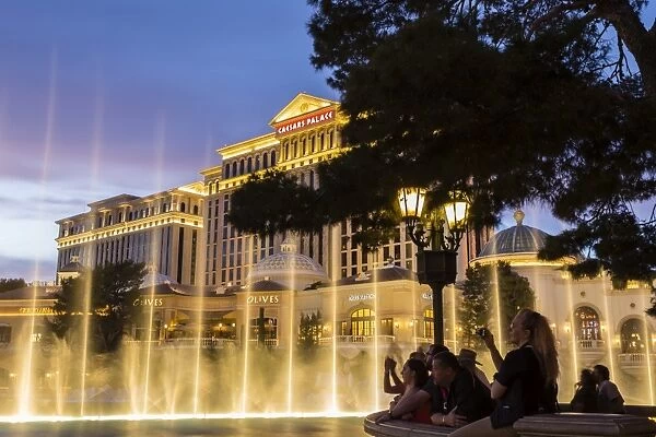 Watching the Bellagio Fountains at dusk, The Strip, Las Vegas, Nevada, United States of America, North America