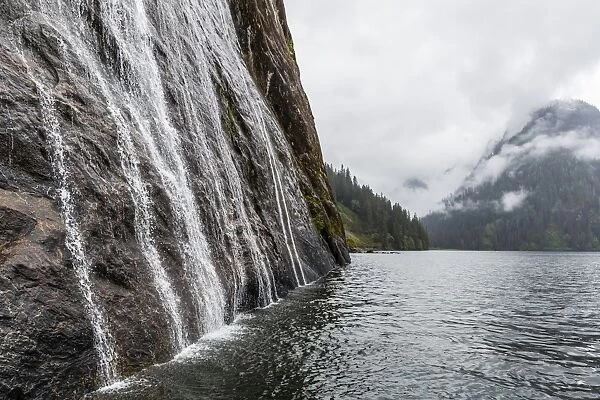 Water cascading down cliffs in Misty Fjord National Park, Alaska, United States of America