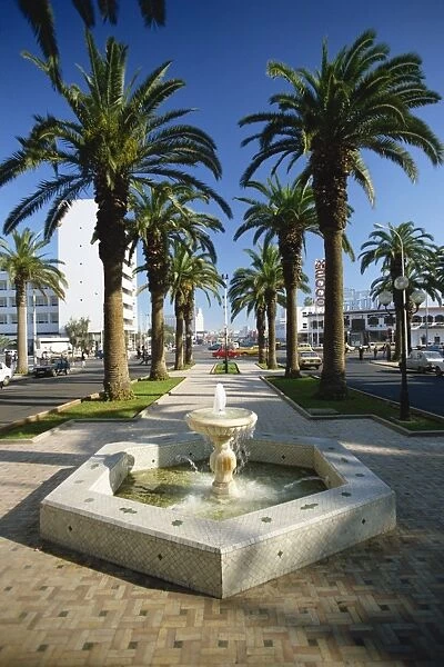 Water fountain and palm trees on the promenade on Boulevard