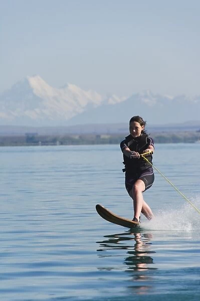 Water skier on Lake Benmore and a distant Aoraki (Mount Cook)