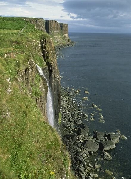 Waterfall over cliff into the sea