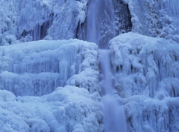 Waterfall iced over in winter in Franche-Comte, France, Europe