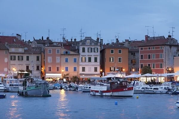 Waterfront and harbour with ships and boats at dusk, Rovinj, Istria, Croatia, Europe