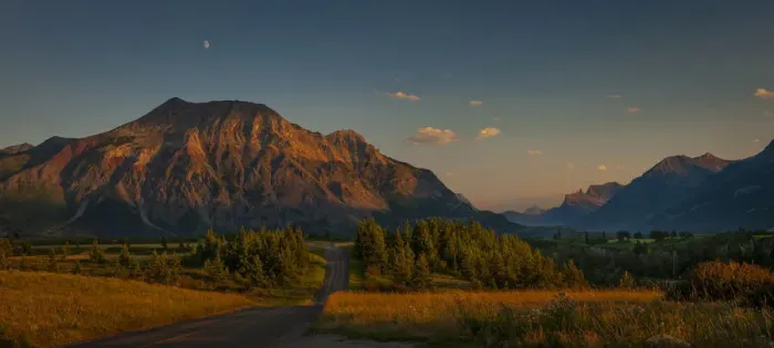 Framed Print : Waterton-Glacier mountains at sunset, UNESCO World Heritage Biosphere site with a lone Framed Print : Waterton-Glacier mountains at sunset, UNESCO World Heritage Biosphere site with a lone