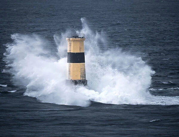 Waves crash on Tourelle de la Plate Lighthouse, Pointe du Raz, Finistere, Brittany