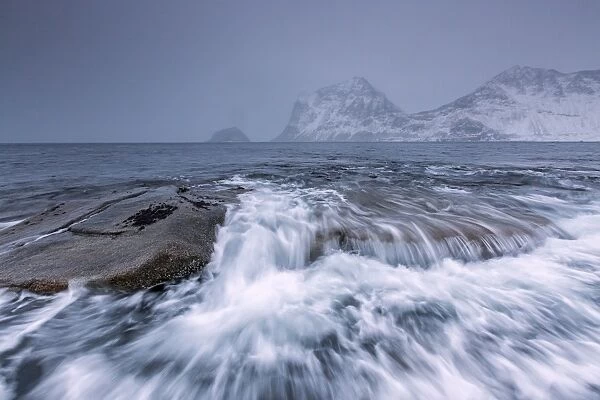 Waves crashing on the rocks of the cold sea, Haukland, Lofoten Islands, Northern Norway