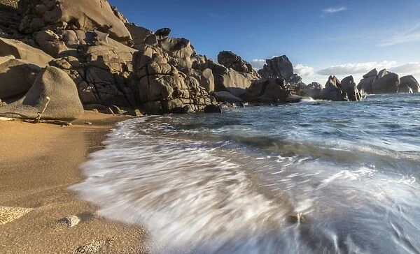 Waves crashing on the sandy beach framed by cliffs, Capo Testa, Santa Teresa di Gallura