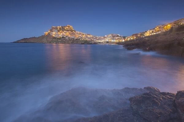 Waves frame the village perched on promontory at dusk, Castelsardo, Gulf of Asinara