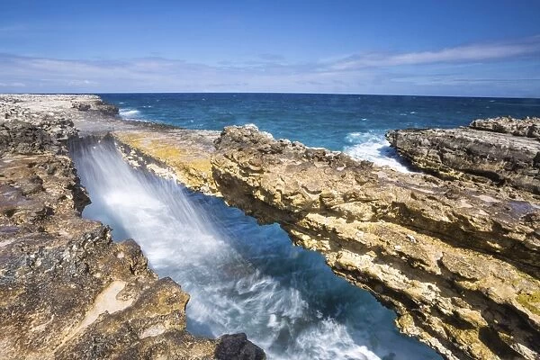 Waves in the natural arches of limestone Devils Bridge, Antigua, Antigua and Barbuda