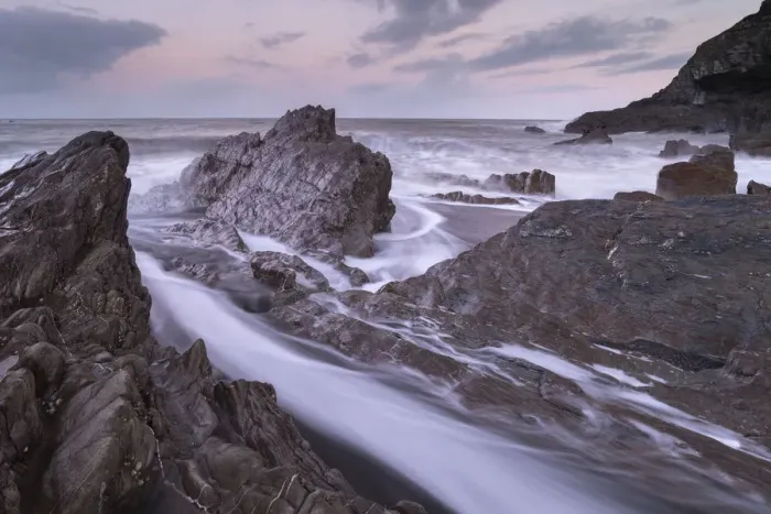 Framed Print : Waves surge around the jagged rocks on Wildersmouth Beach, Ilfracombe, Devon, England Framed Print : Waves surge around the jagged rocks on Wildersmouth Beach, Ilfracombe, Devon, England