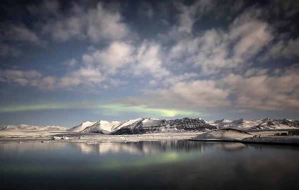 Weak winter Aurora Borealis (Northern Lights) over Jokulsarlon Glacial Lagoon, South Iceland