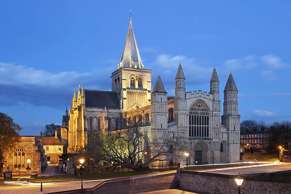 The west front of the Norman built Rochester Cathedral floodlit at night, Rochester, Kent