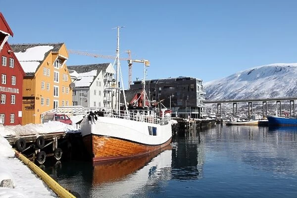 The whaler that used to go to Svalbard, with warehouses behind that have been converted into offices, Tromso, Troms, Norway, Scandinavia, Europe