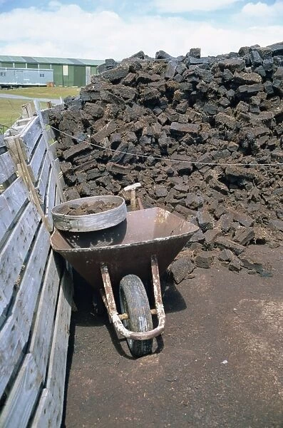 Wheelbarrow and peat stack at a settlement on the Falkland Islands, South America