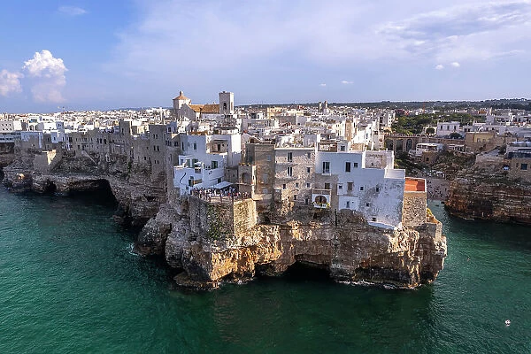 The white buildings on top of the cliff of the fishing village of Polignano a Mare, Bari province, Apulia, Italy, Europe