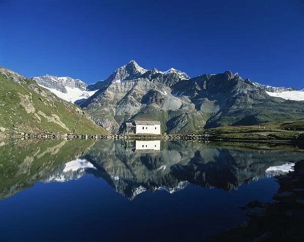 White chapel and Ober Gabelhorn reflected in the Schwarzsee
