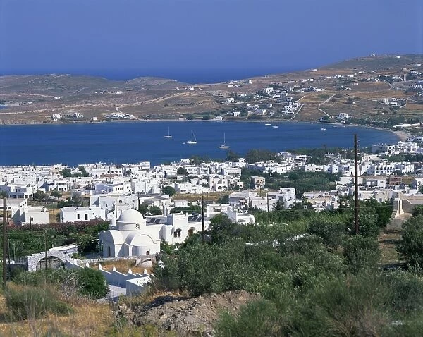 White church and houses overlooking a bay on Paros