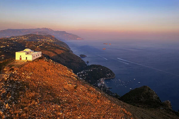 White church of San Costanzo on top of a mountain surrounding the Amalfi coast at sunset, Punta Campanella, Massa Lubrense, Naples province, Campania, Italy, Europe