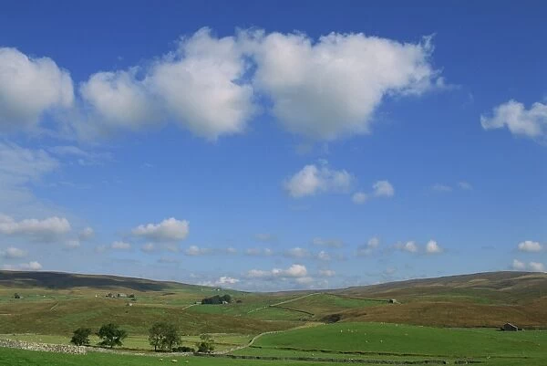 White clouds and blue skies over dales landscape near Ribble Head, North Yorkshire