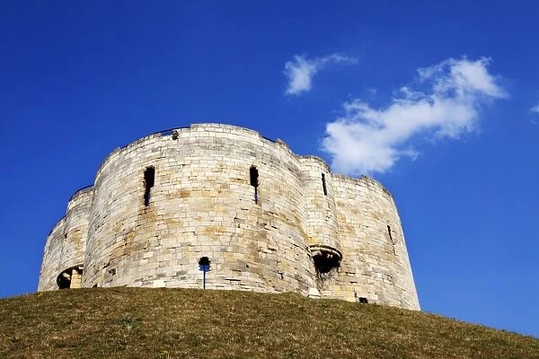 White clouds in blue sky above Cliffords Tower, City of York, Yorkshire, England, United Kingdom, Europe