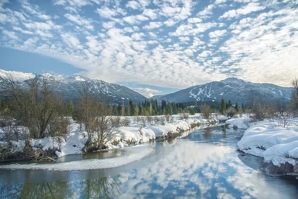 White clouds reflect over the River of Golden Dreams in Whistler, British Columbia