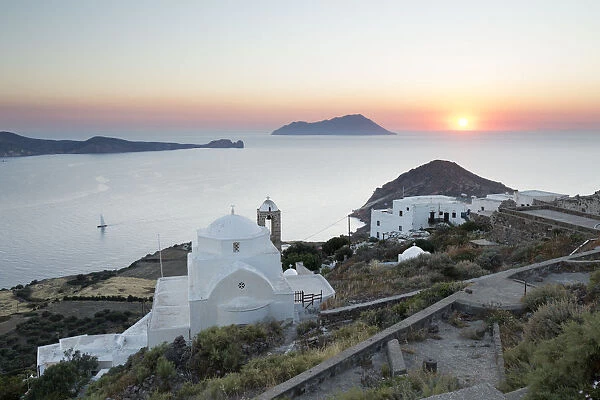 White Greek church and Milos Bay from Plaka Castle at sunset, Plaka, Milos, Cyclades