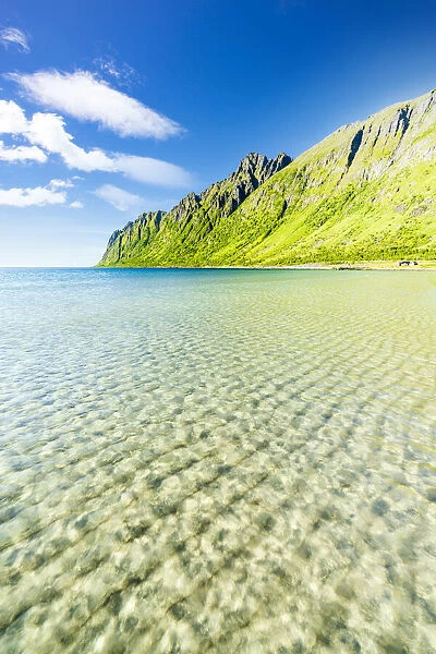 White sand washed by turquoise clear sea with mountains on background, Ersfjord beach