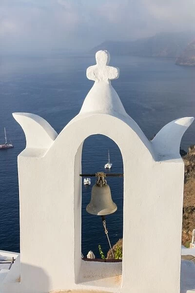The white steeple of the church and the blue Aegean Sea as symbols of Greece, Oia