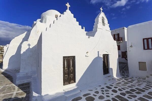 Whitewashed Panagia Paraportiani, Mykonos most famous church, under a blue sky, Mykonos Town
