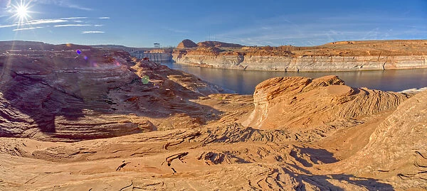 Wide angle view of Glen Canyon Dam from the wavy sandstone mesa of an area called