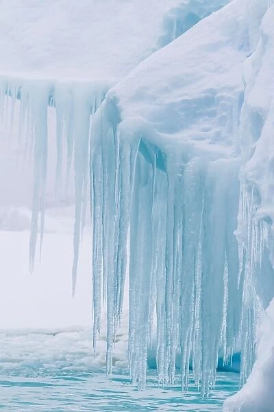 Wind and water sculpted iceberg with icicles at Booth Island, Antarctica, Polar Regions
