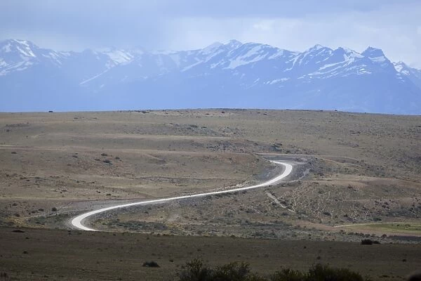 Winding desert road and Andes mountains, El Calafate, Parque Nacional Los Glaciares