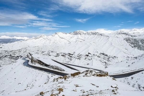 Winding road through Tizi N Tichka pass in the Atlas Mountains during winter snow