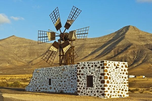 Windmill in the central valley and the 625m high Churillos mountain beyond, Tefia, Puerto del Rosario, Fuerteventura, Canary Islands, Spain, Europe