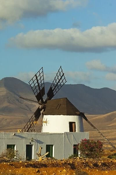 Windmill in the central valley and the 625m high Churillos mountain beyond, Llanos de la Concepcion, Fuerteventura, Canary Islands, Spain, Europe