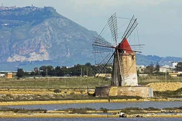 Windmill on Stagnone Lagoon in the salt pan area south of Trapani, with Mount Erice in the distance, Marsala, Sicily, Italy, Mediterranean, Europe