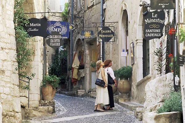 Window shopping in medieval village street, St. Paul de Vence, Alpes-Maritimes