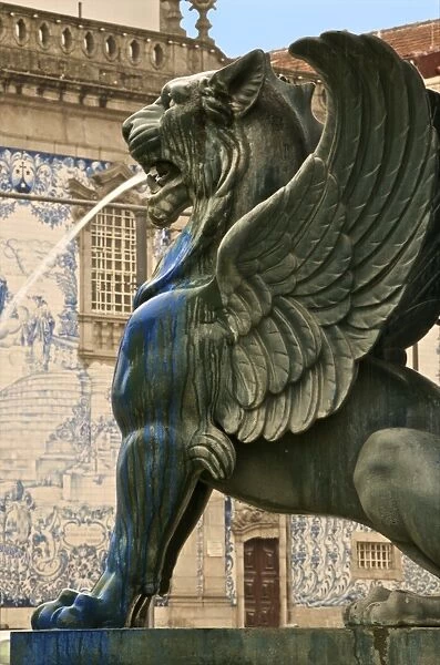Winged lion fountain in front of azulejos tiles on the Do Carmo church dating from the 18th century