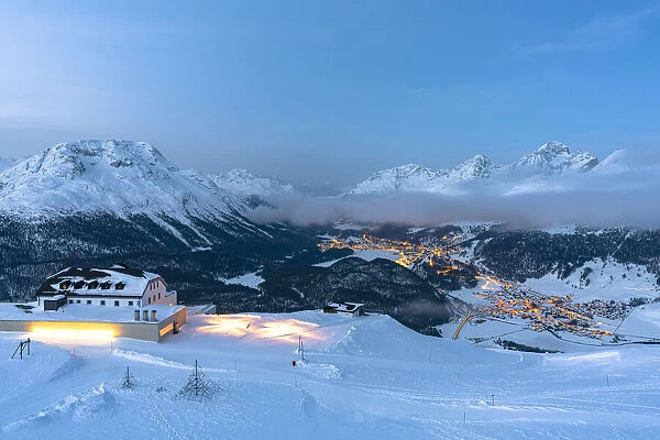 Winter dusk over St. Moritz and Celerina villages covered with snow from Muottas Muragl