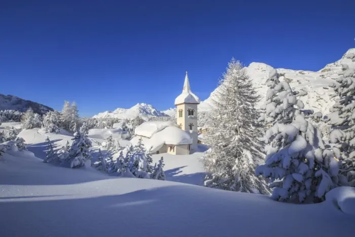 Framed Print : The winter sun illuminates the snowy landscape and the typical church, Maloja, Engadine Framed Print : The winter sun illuminates the snowy landscape and the typical church, Maloja, Engadine